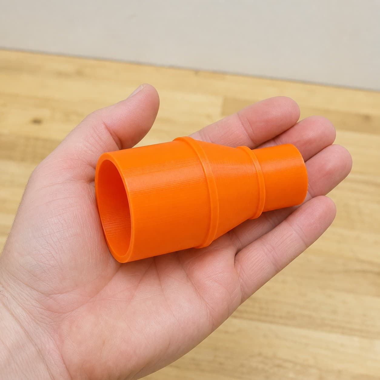 The 9404 to 36mm Festool dust adapter held in one hand to show its size