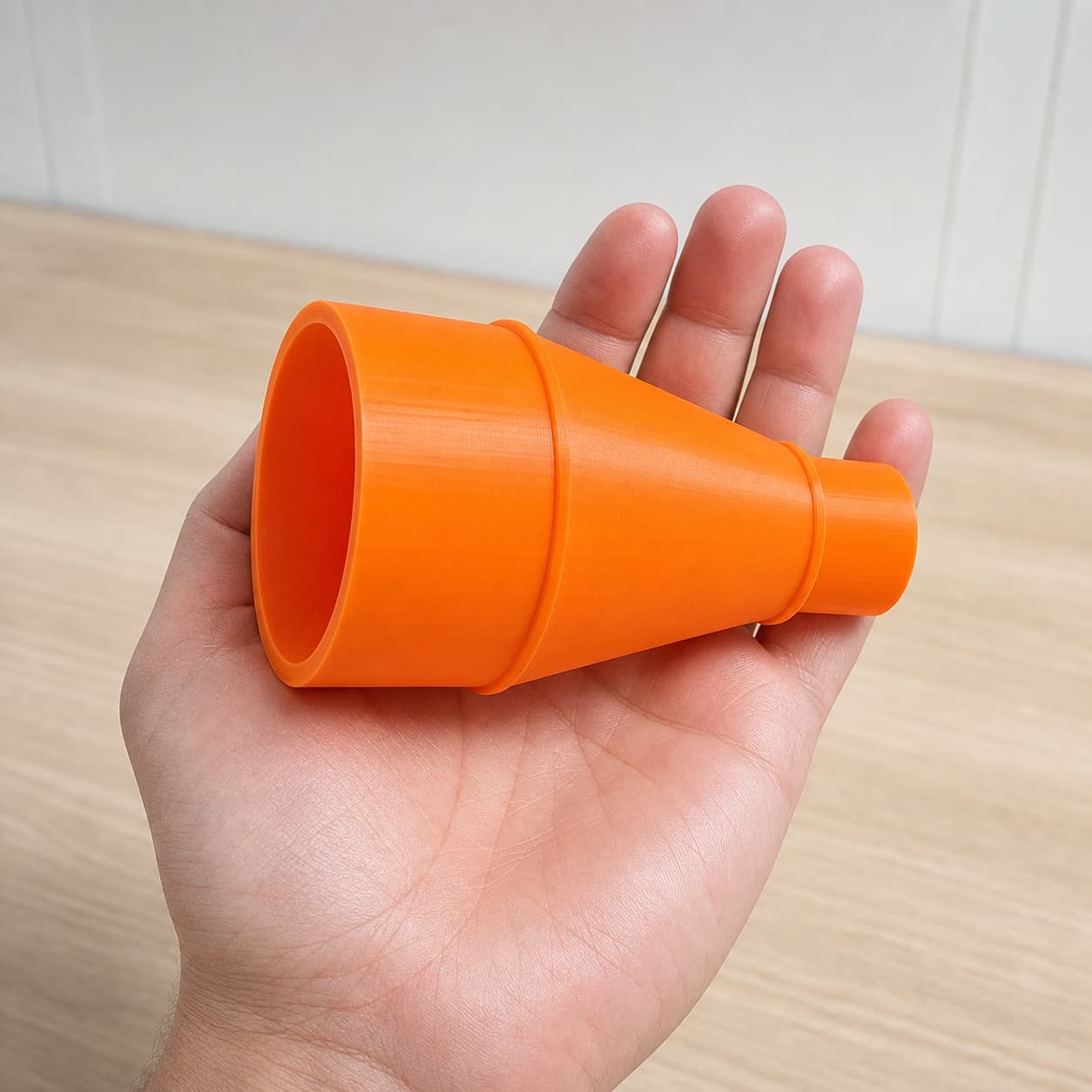 The DCS334B to 2.5" Duct dust adapter held in one hand to show its size