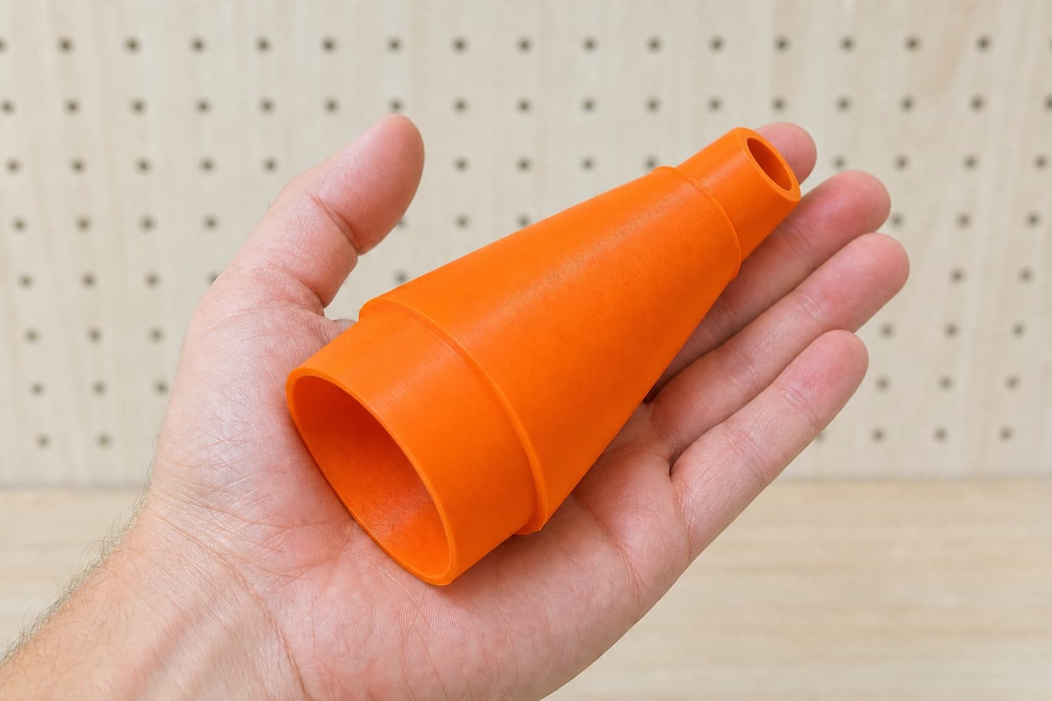 The DCS391B to 3" Duct dust adapter held in one hand to show its size