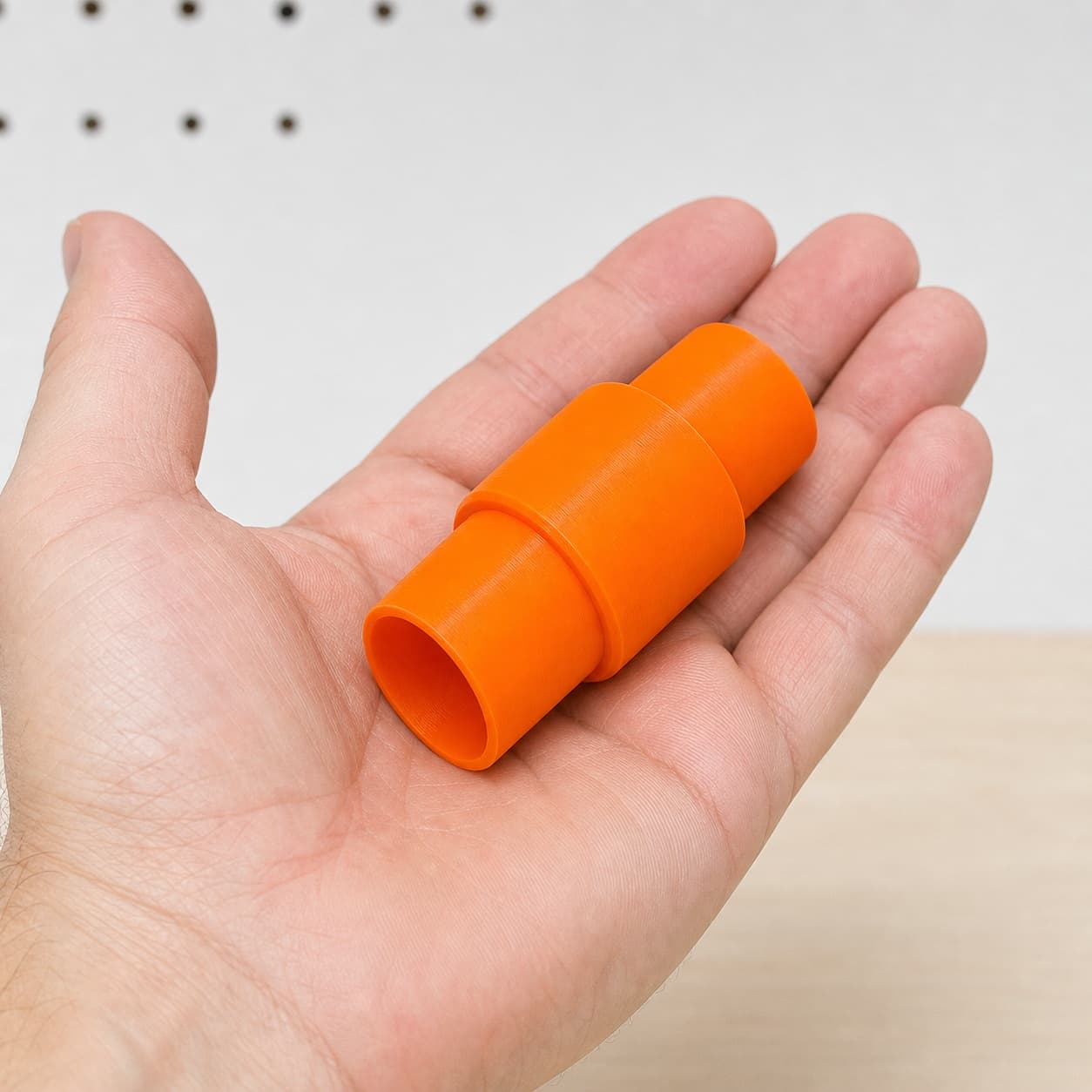 The XTR01Z to 36mm Festool dust adapter held in one hand to show its size