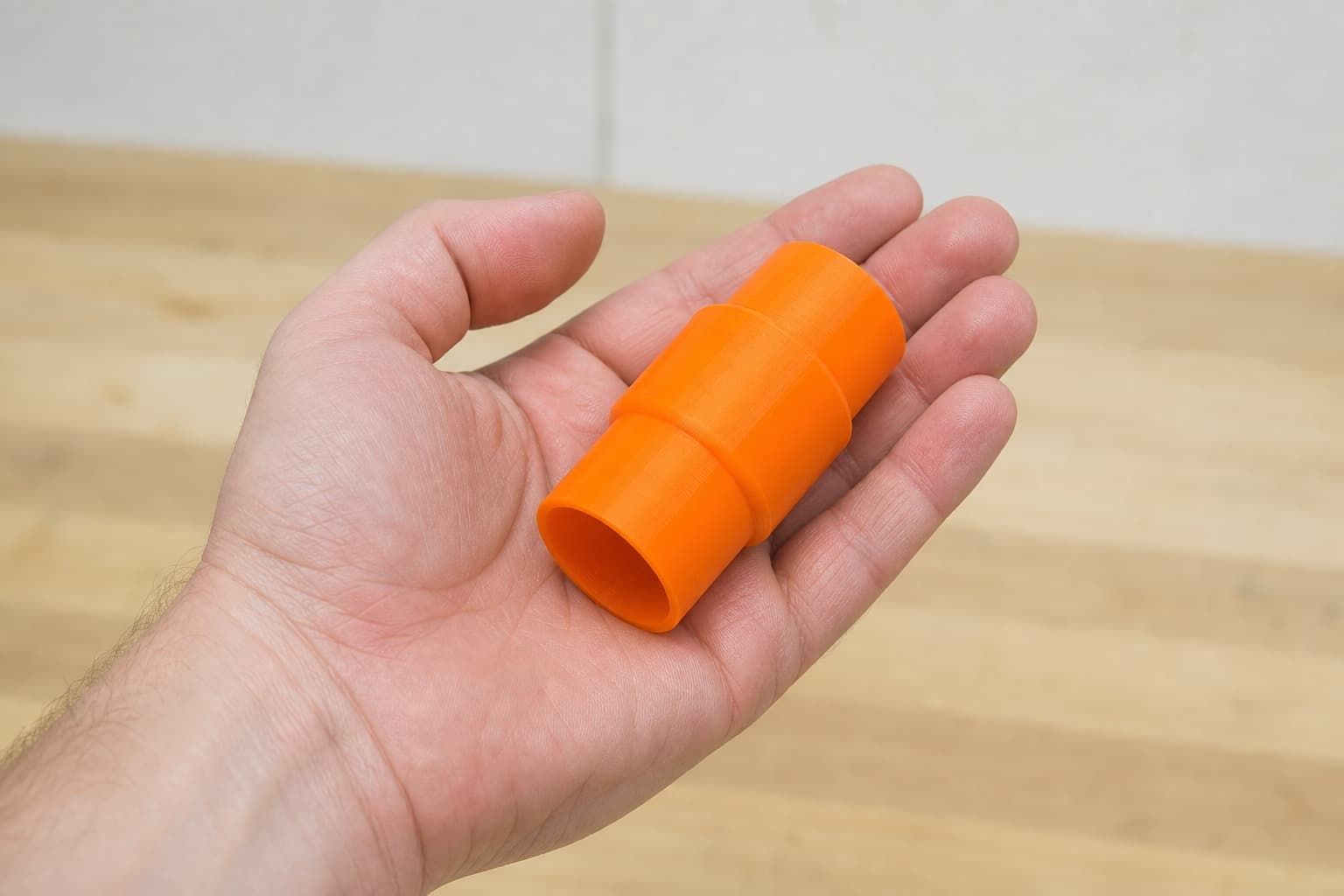The DWS713 to Festool CT 36 dust adapter held in one hand to show its size