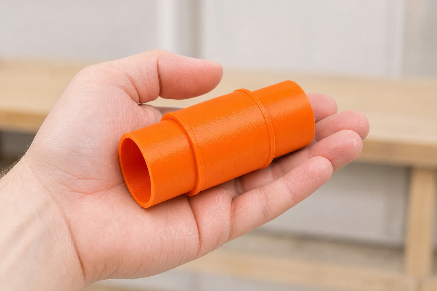 The XSH06Z to Bosch GAS18V-10L dust adapter held in one hand to show its size
