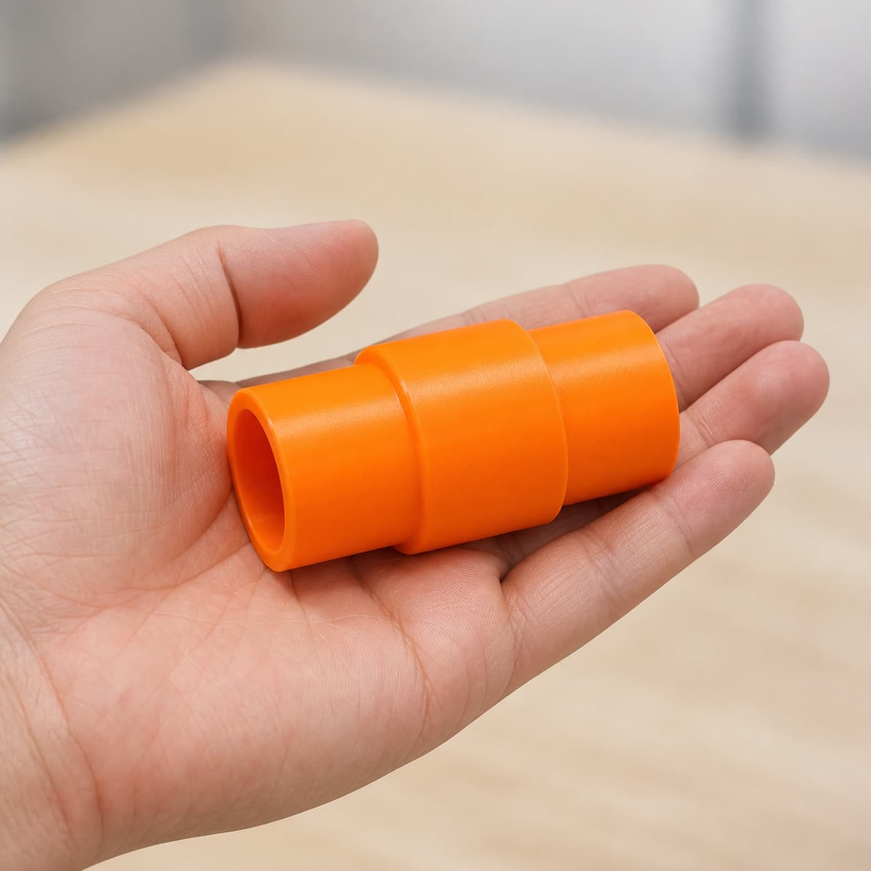 The XSH06Z to 36mm Festool dust adapter held in one hand to show its size
