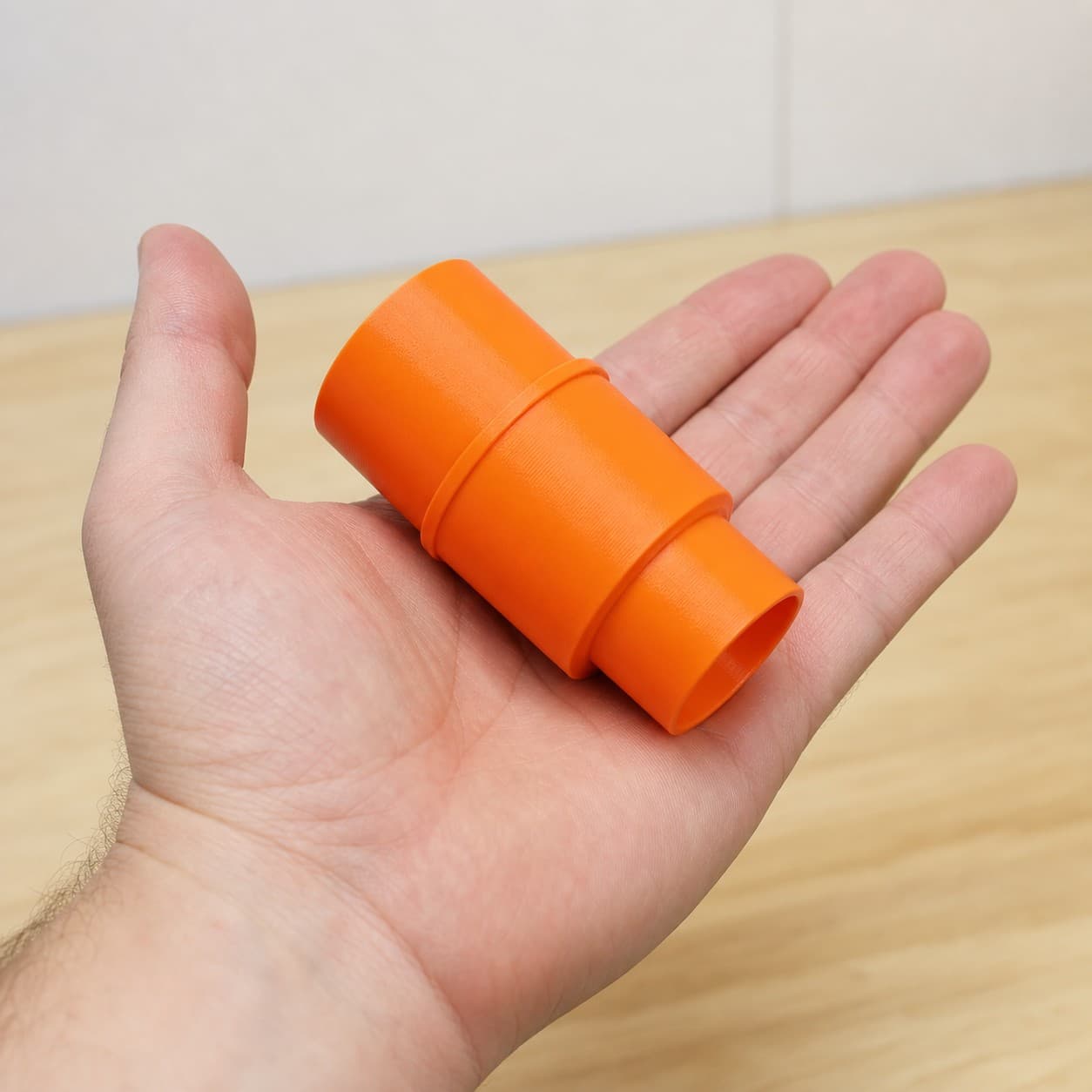The XSH06Z to Craftsman 20G dust adapter held in one hand to show its size