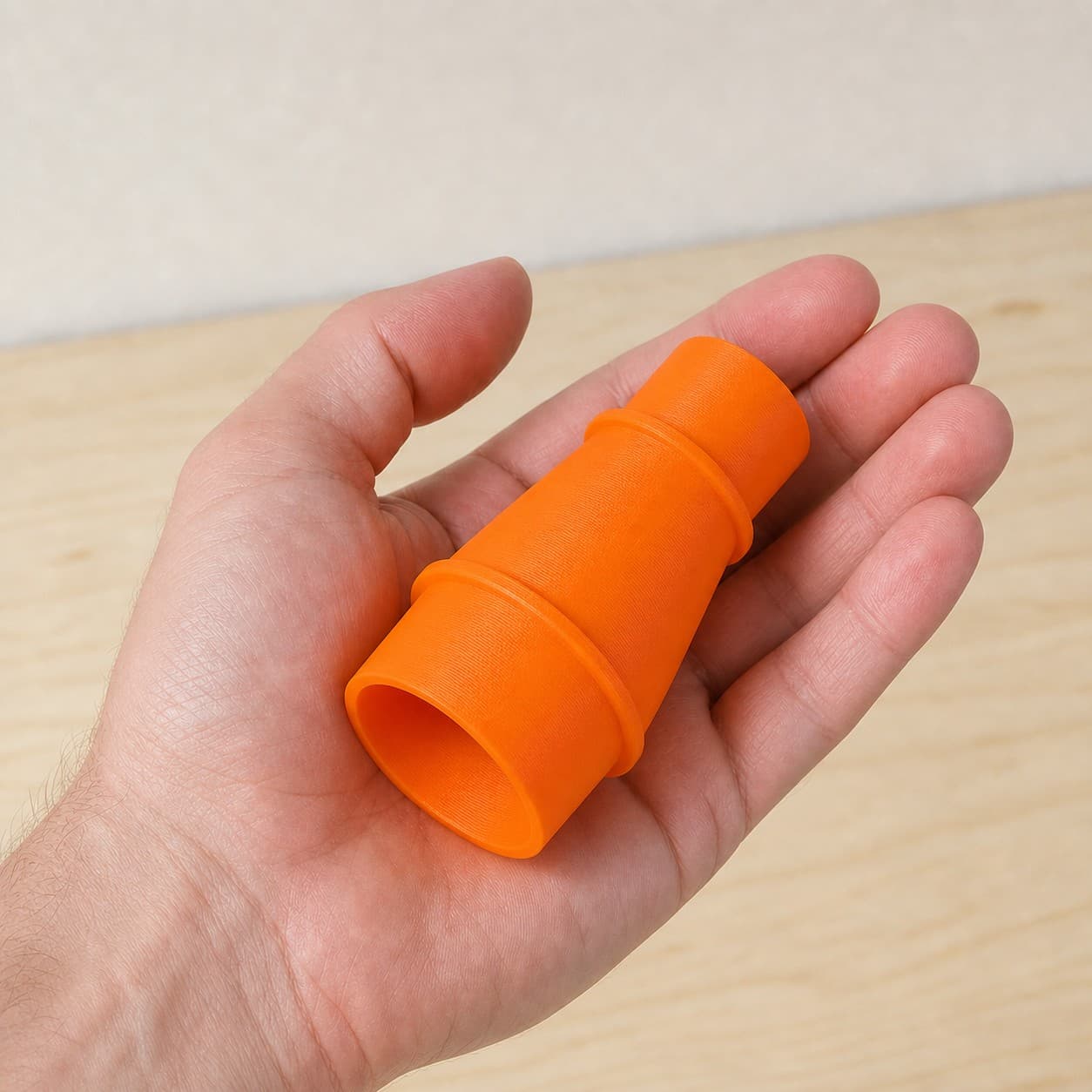 The DCS335B to 1.875" Shop Vac dust adapter held in one hand to show its size