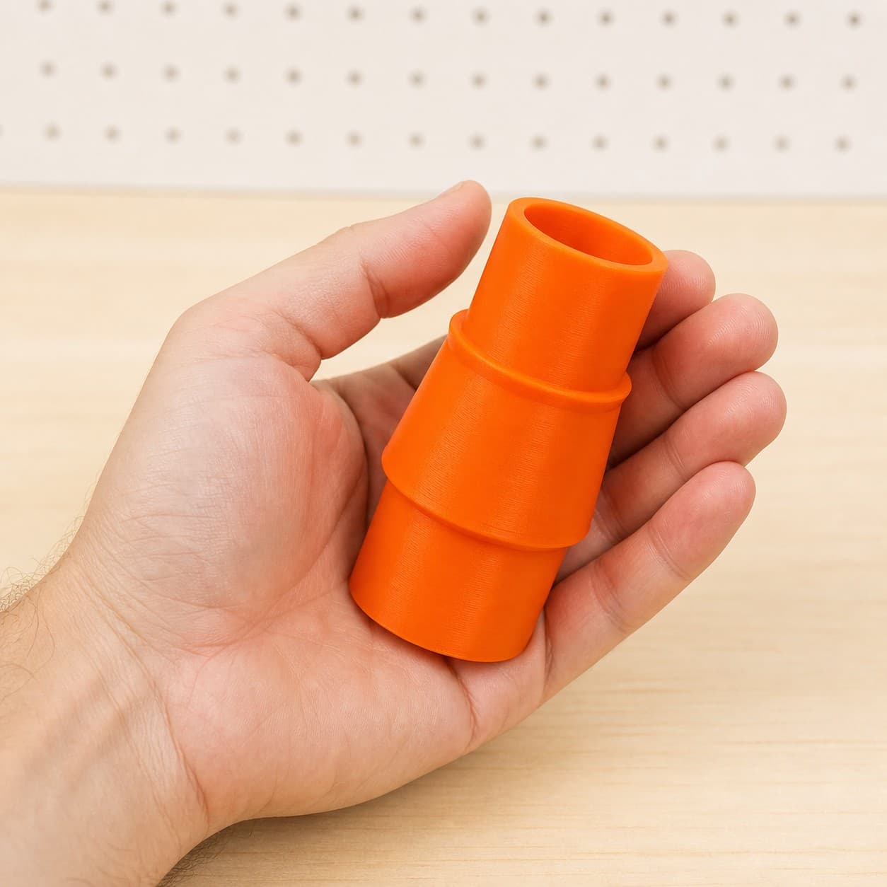 The CMXEMAX69434501 to 1.25" Duct dust adapter held in one hand to show its size