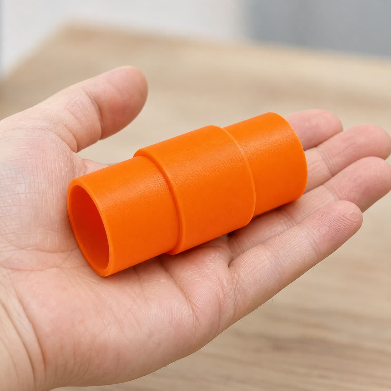 The 69033 to Festool CT 36 dust adapter held in one hand to show its size