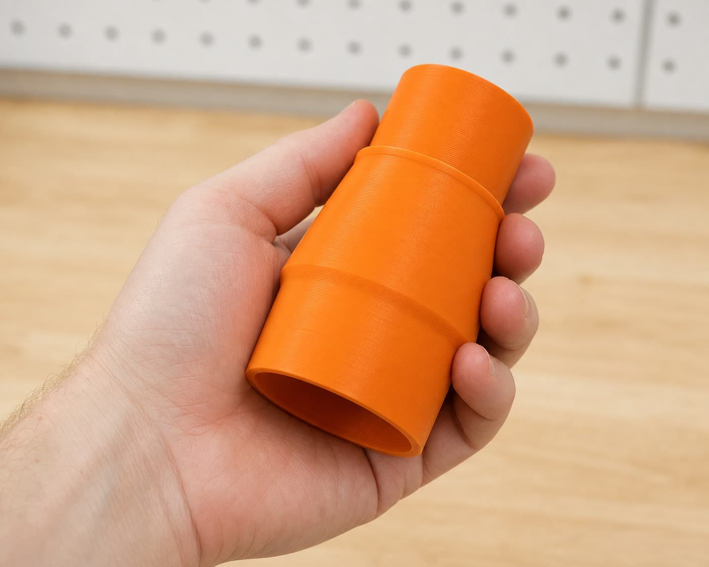 The DCP580B to Bauer 6G Vac dust adapter held in one hand to show its size