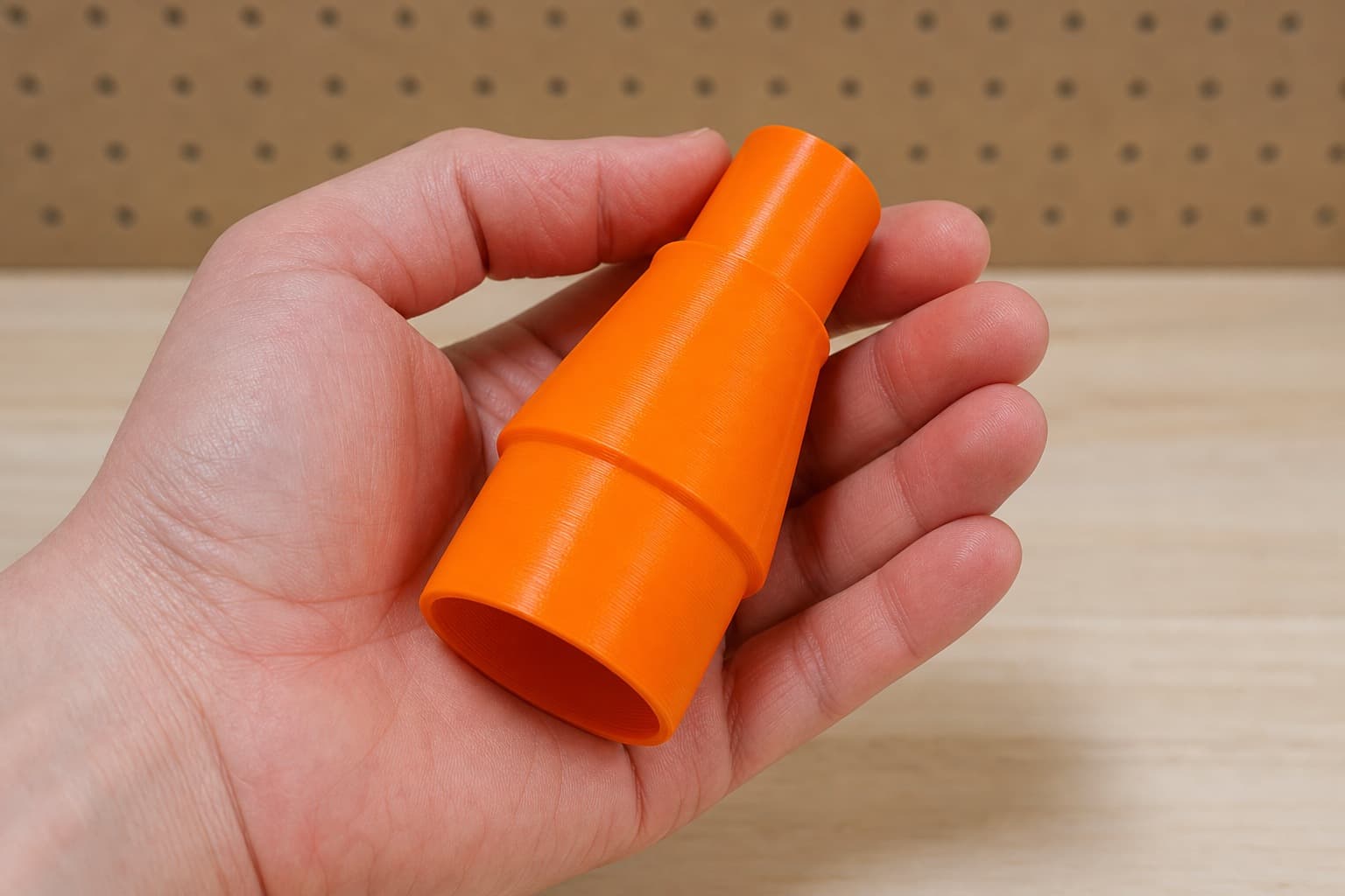 The DKP180 to Festool CT 15 dust adapter held in one hand to show its size