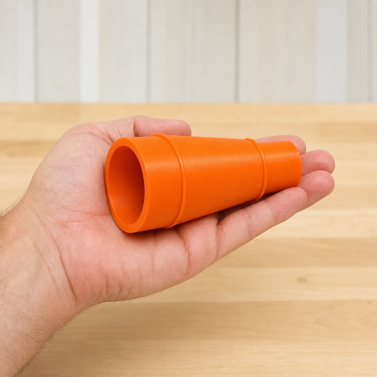 The 58862 to 27mm Festool dust adapter held in one hand to show its size