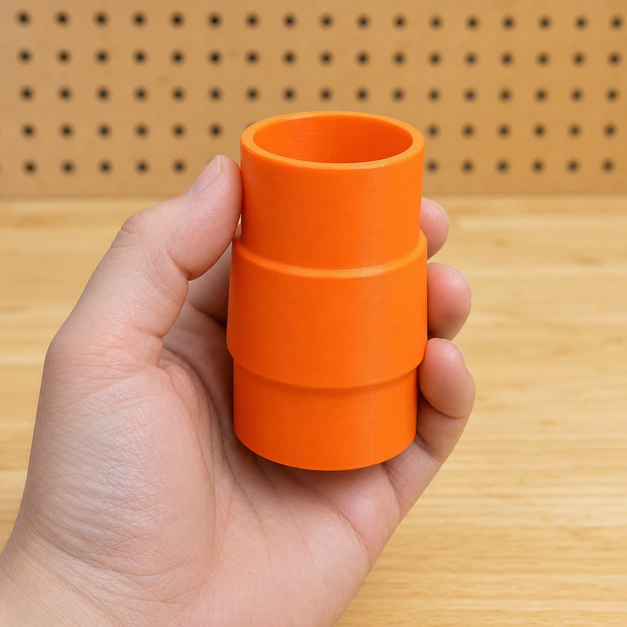 The 58862 to 1.875" Shop Vac dust adapter held in one hand to show its size