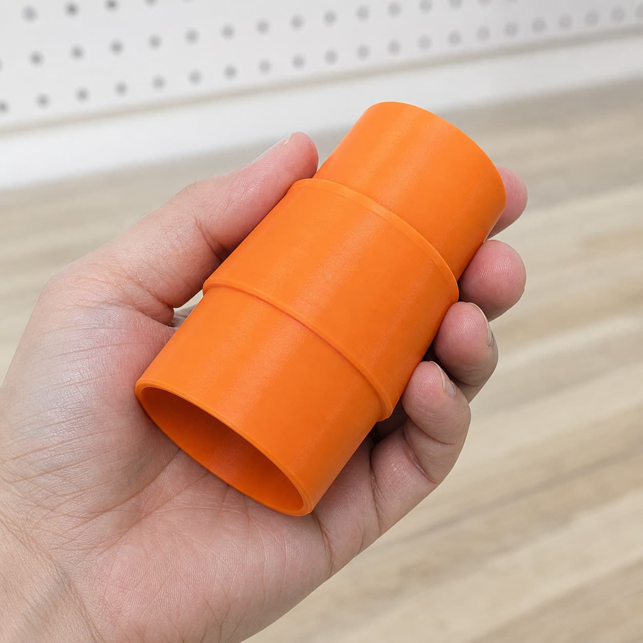 The SM3055LW to 1.875" Shop Vac dust adapter held in one hand to show its size