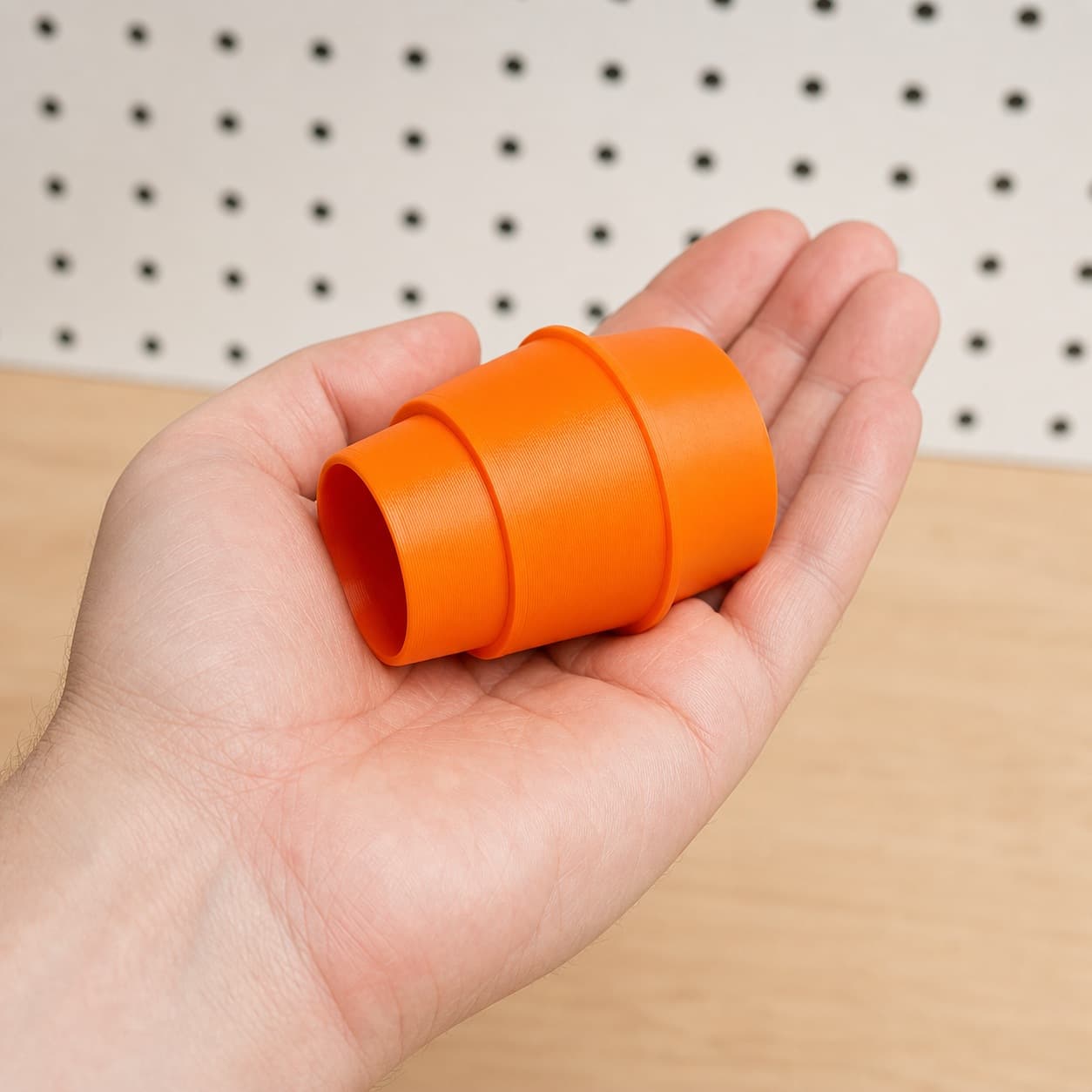 The SM3055LW to Bauer 6G Vac dust adapter held in one hand to show its size