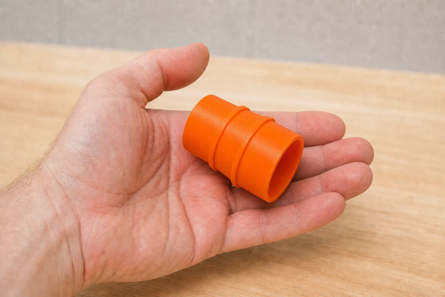 The SPT99 to Craftsman 20G dust adapter held in one hand to show its size