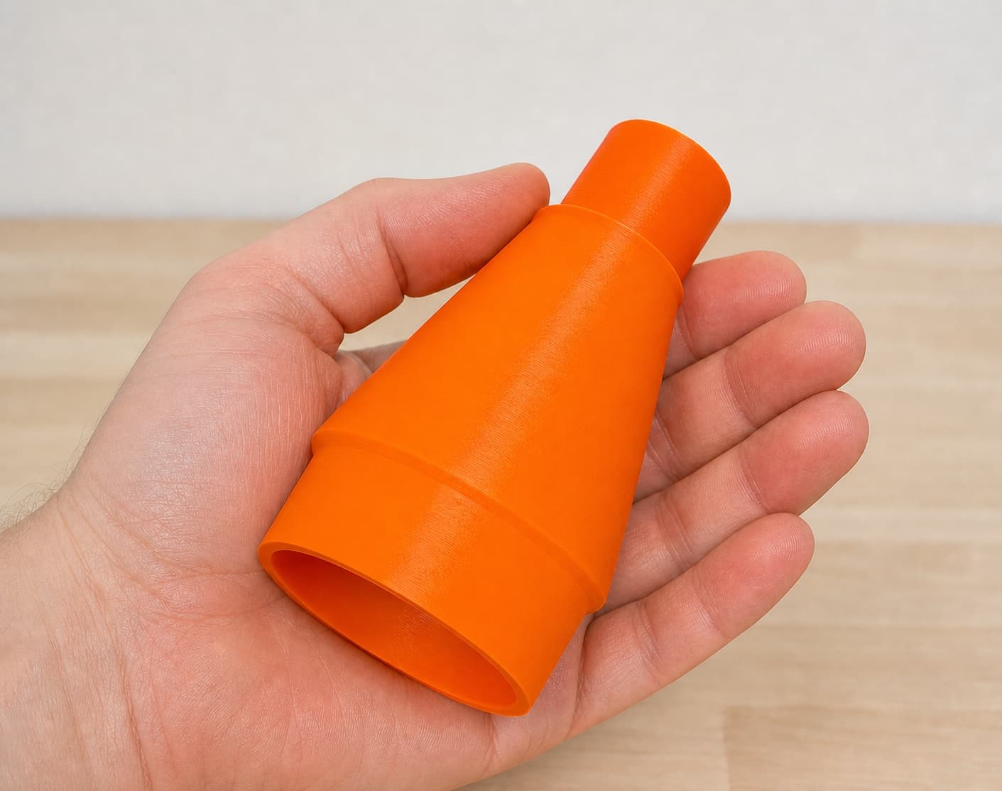 The CMXETAX to 27mm Festool dust adapter held in one hand to show its size