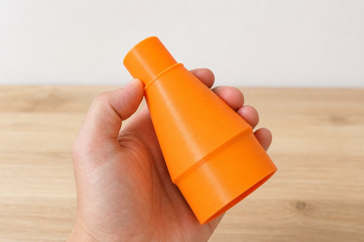 The 59313 to 1.25" Duct dust adapter held in one hand to show its size